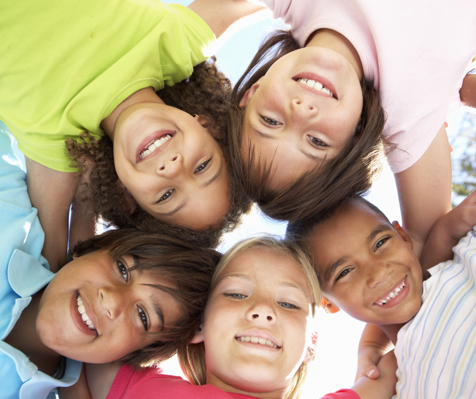 Youth in a circle showing their faces