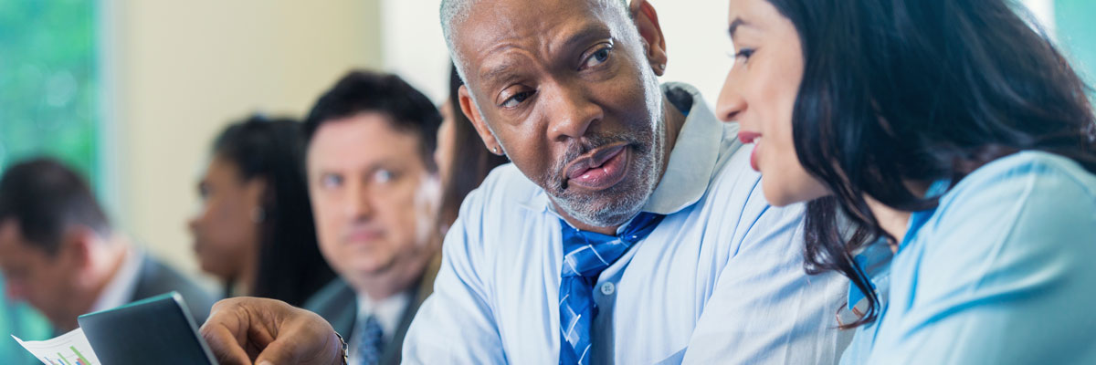 Two co-workers discussion at meeting