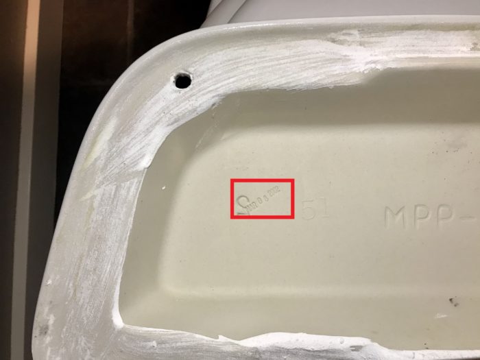 Inside the top lid of the toilet is where the model number can be found.