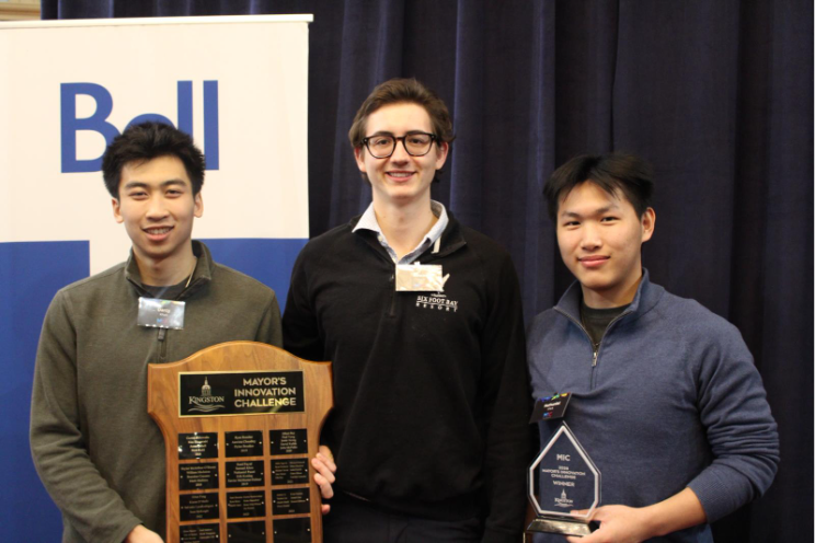 3 members of KPark team, member on the left is holding the Mayor's Innovation Challenge plaque