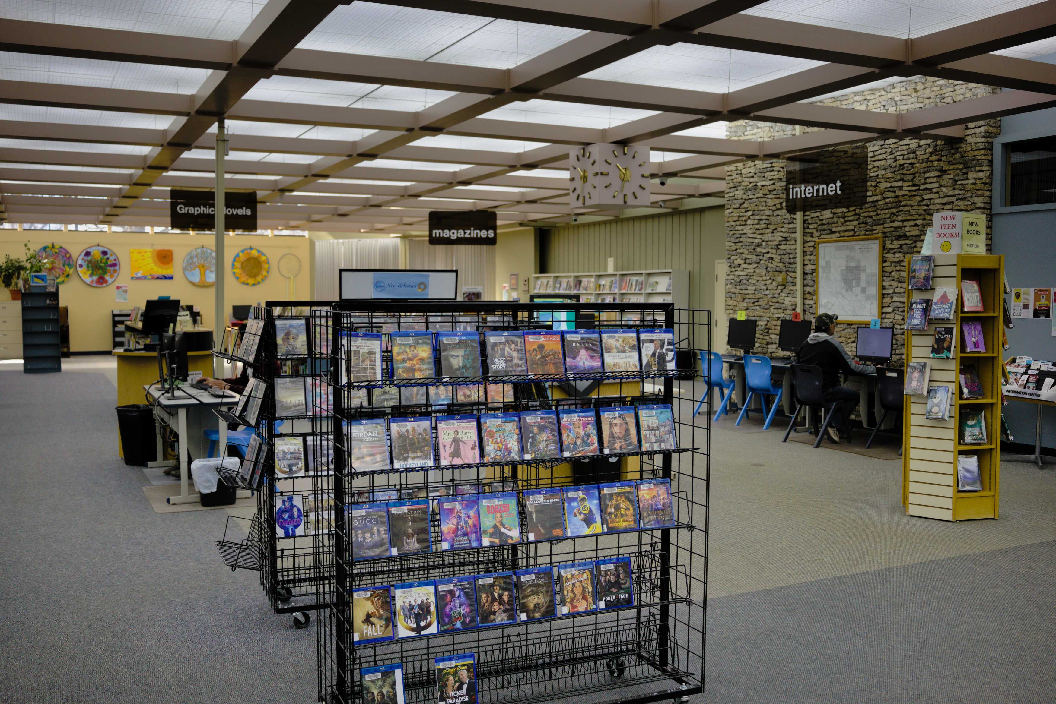Interior of the North Battleford Library with magazine displays, computer stations, and seating.