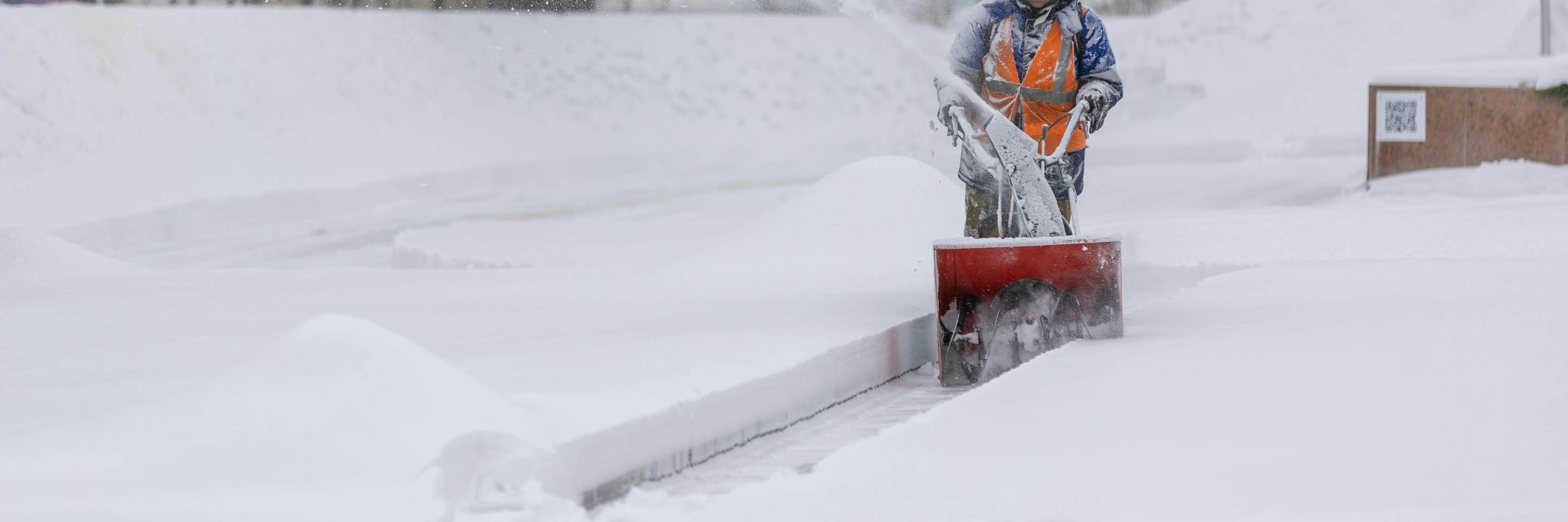 snow blower clearing sidewalk 