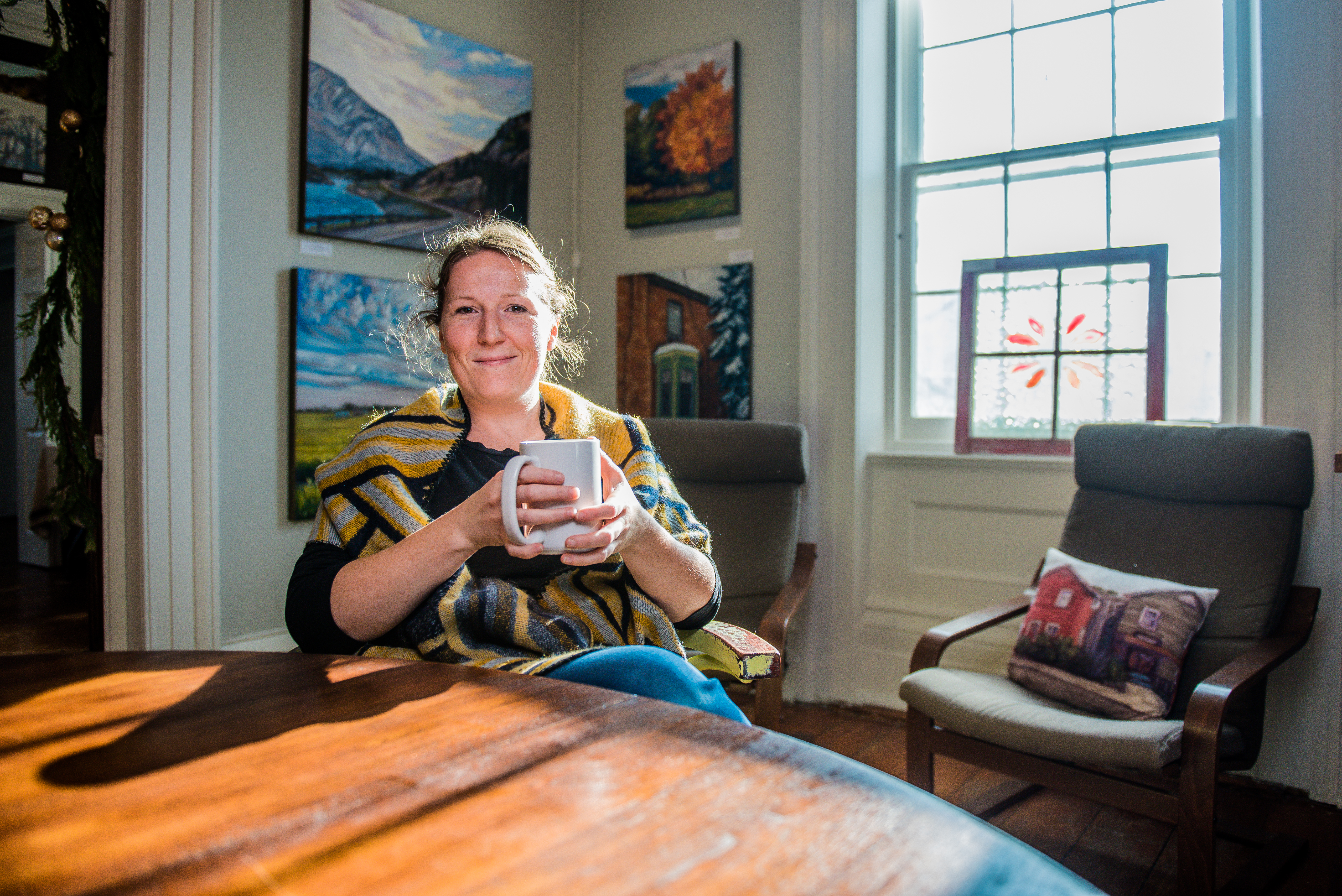 lady sitting in chair holding mug