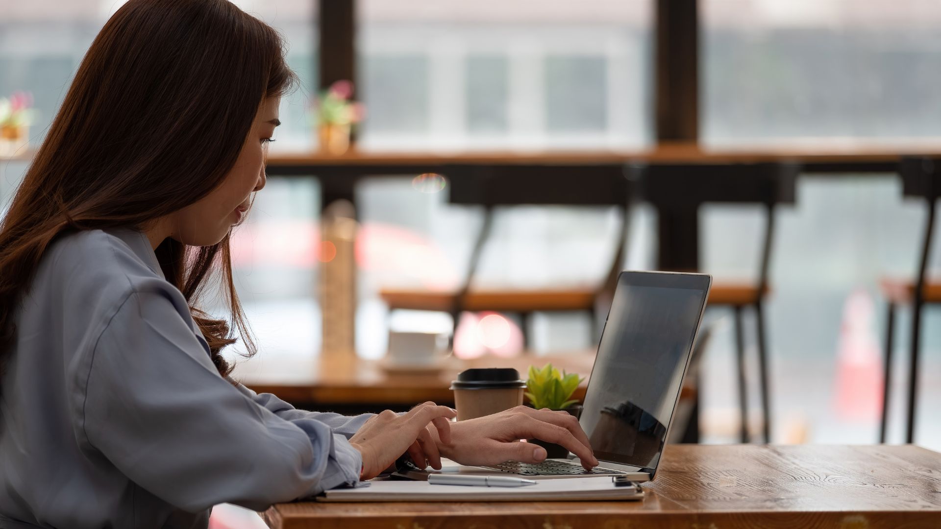 Woman At A Cafe On Her Laptop