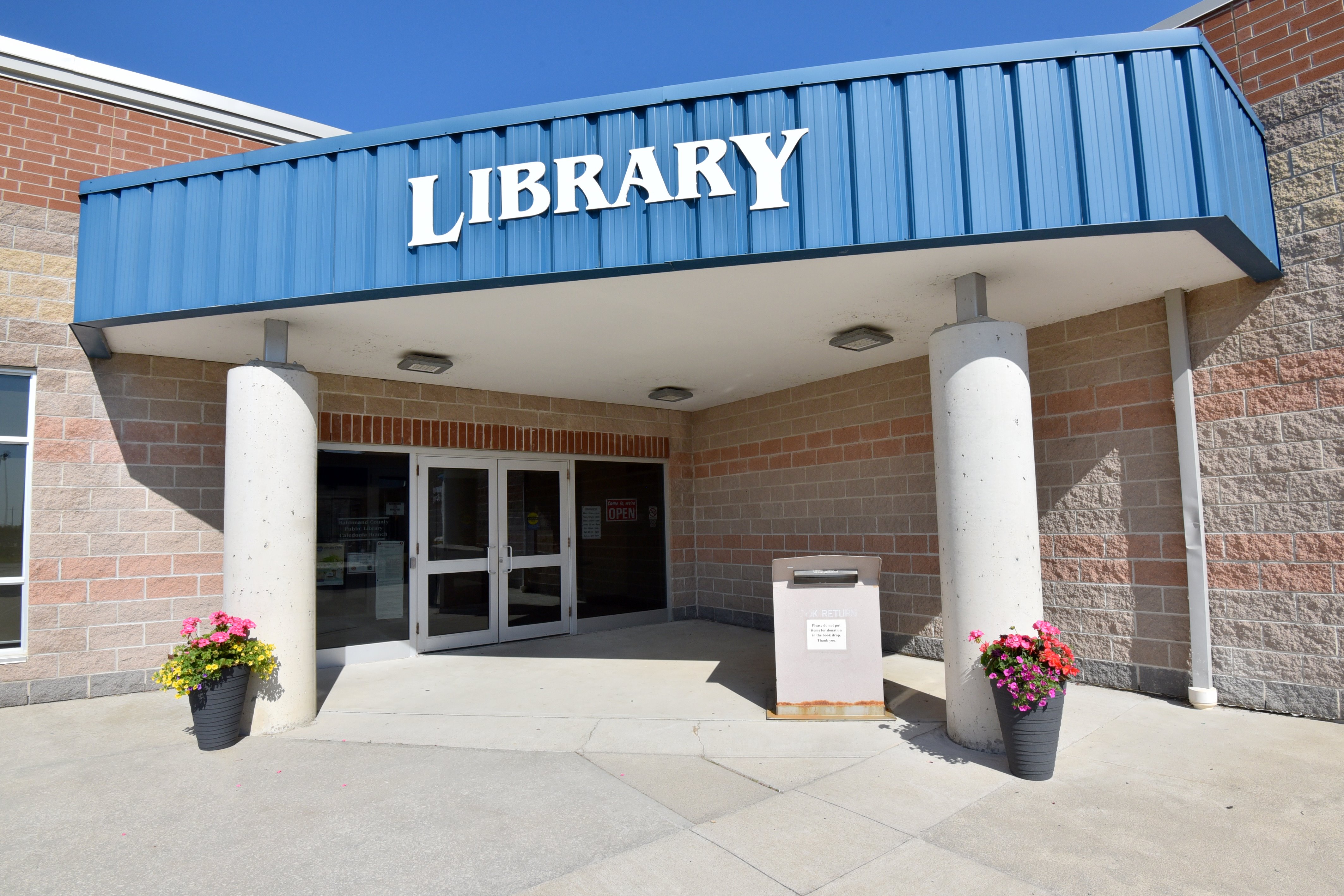 Front entrance of Caledonia Library with "Library" sign