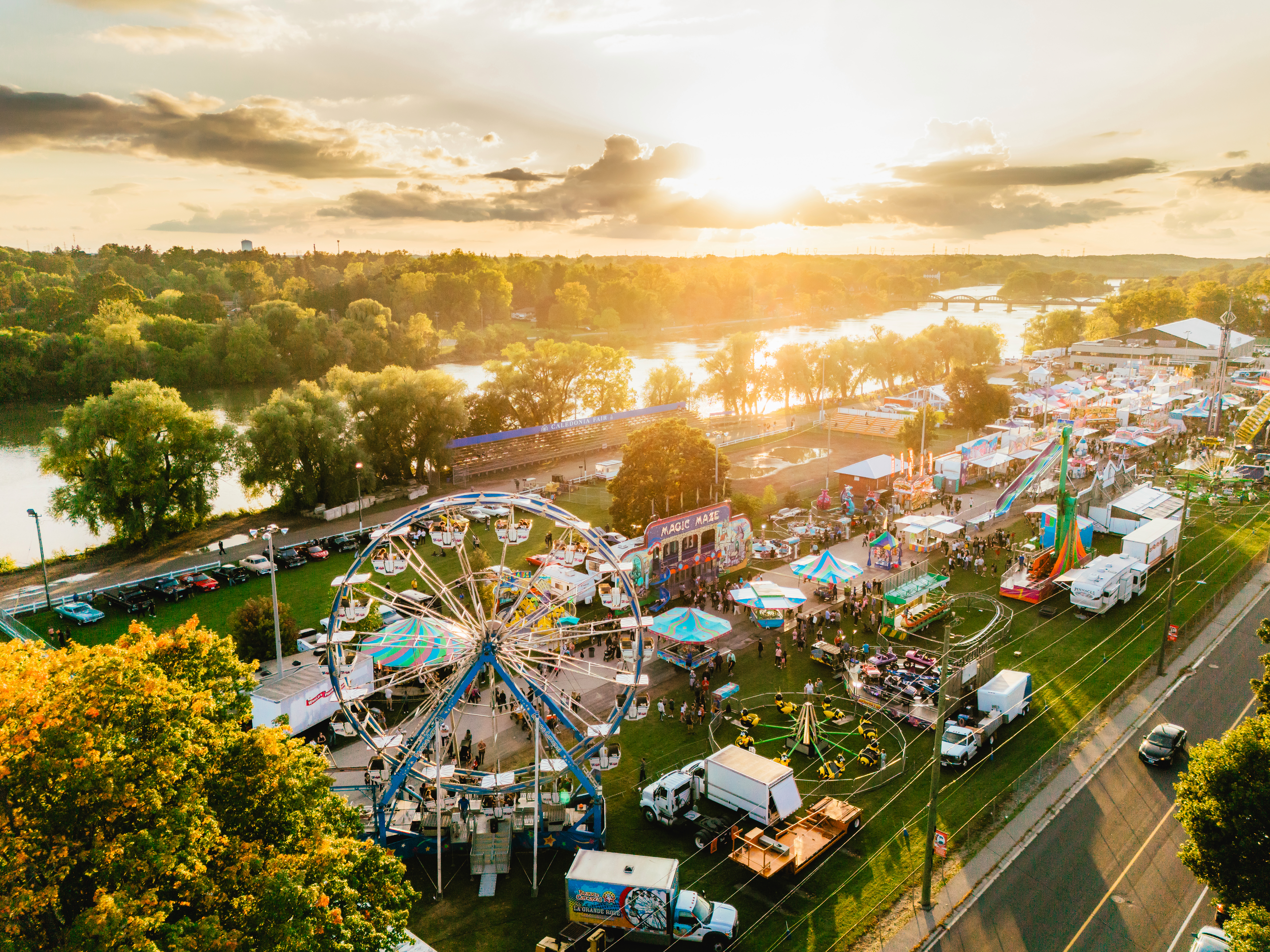 Aerial view of fairgrounds with rides and a ferris wheel