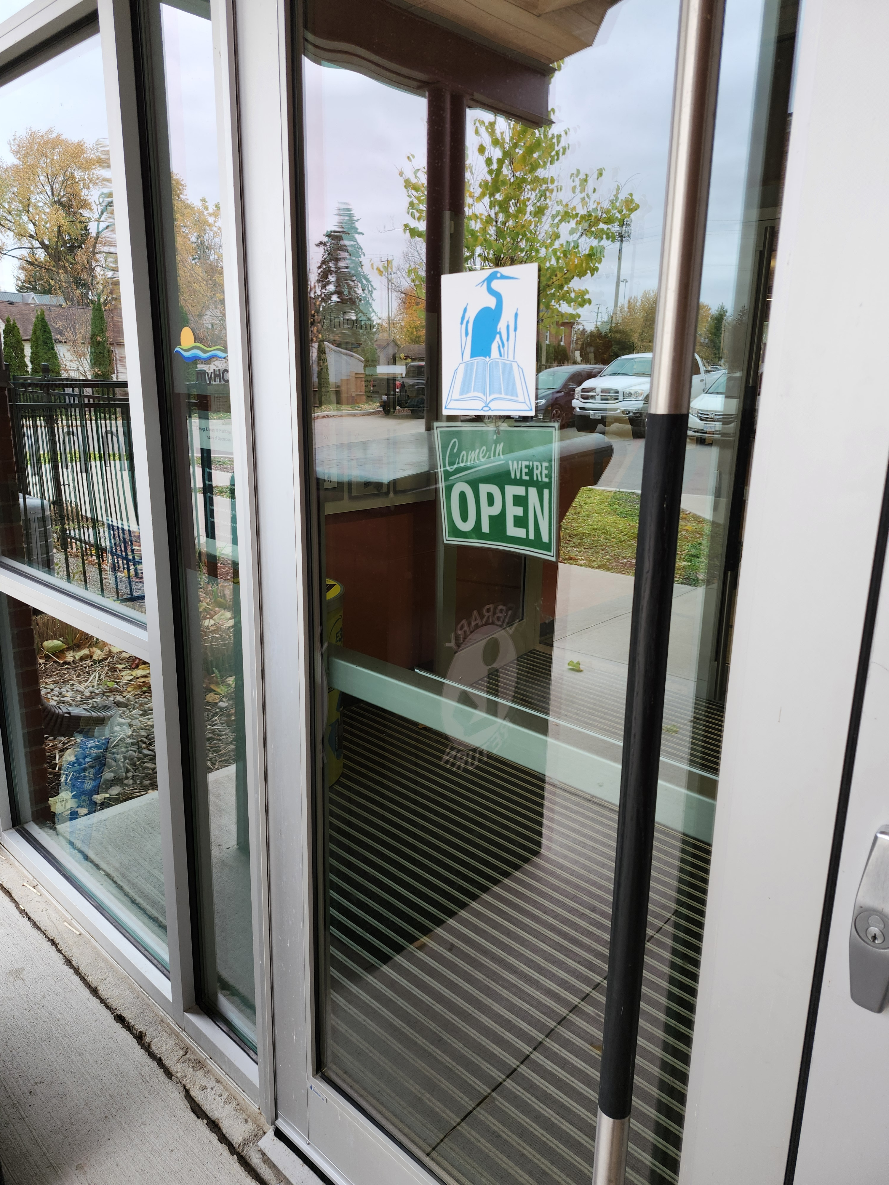 door with library blue heron logo and open sign