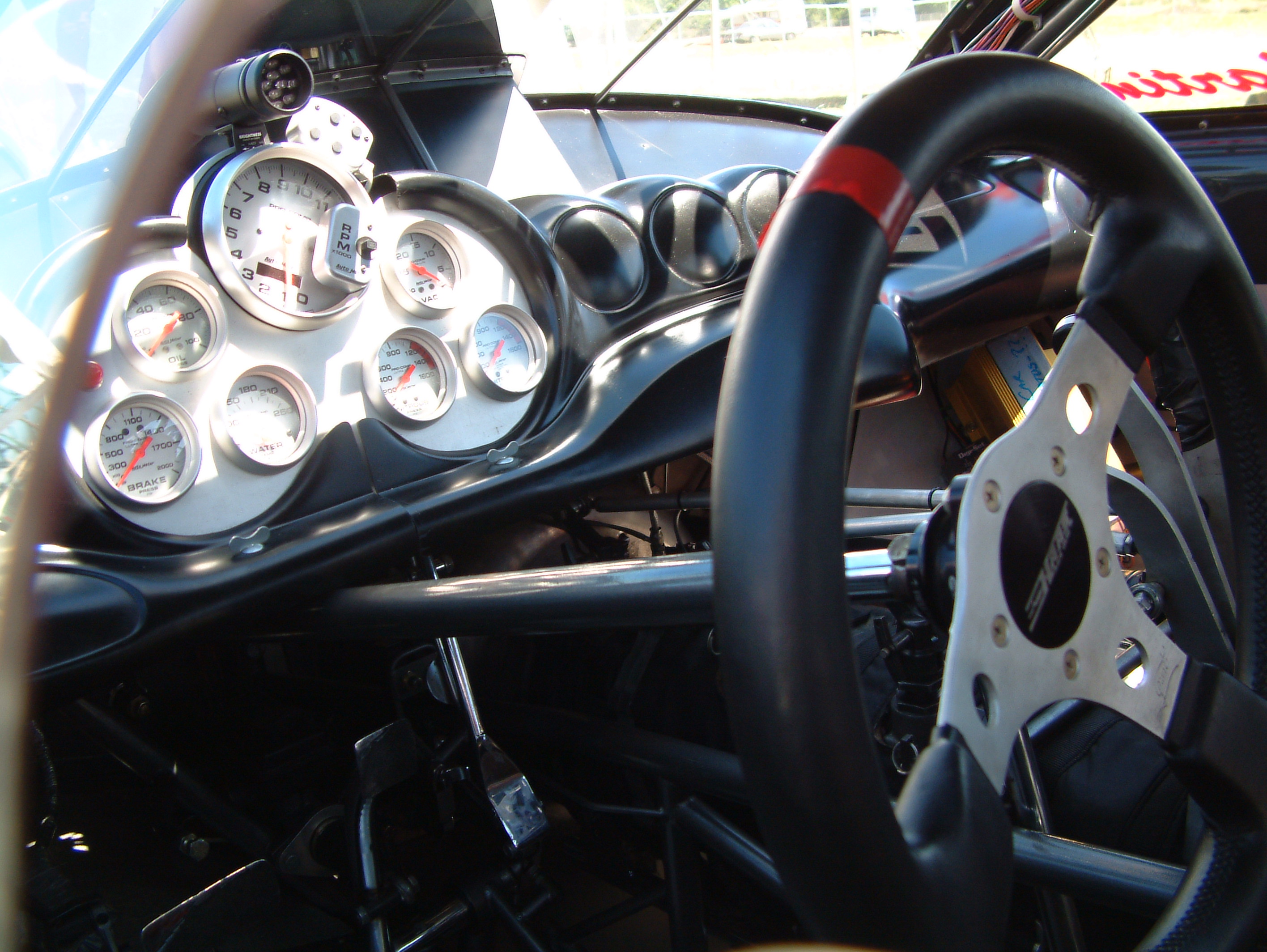 sports car interior showing steering wheel and drivers dashboard