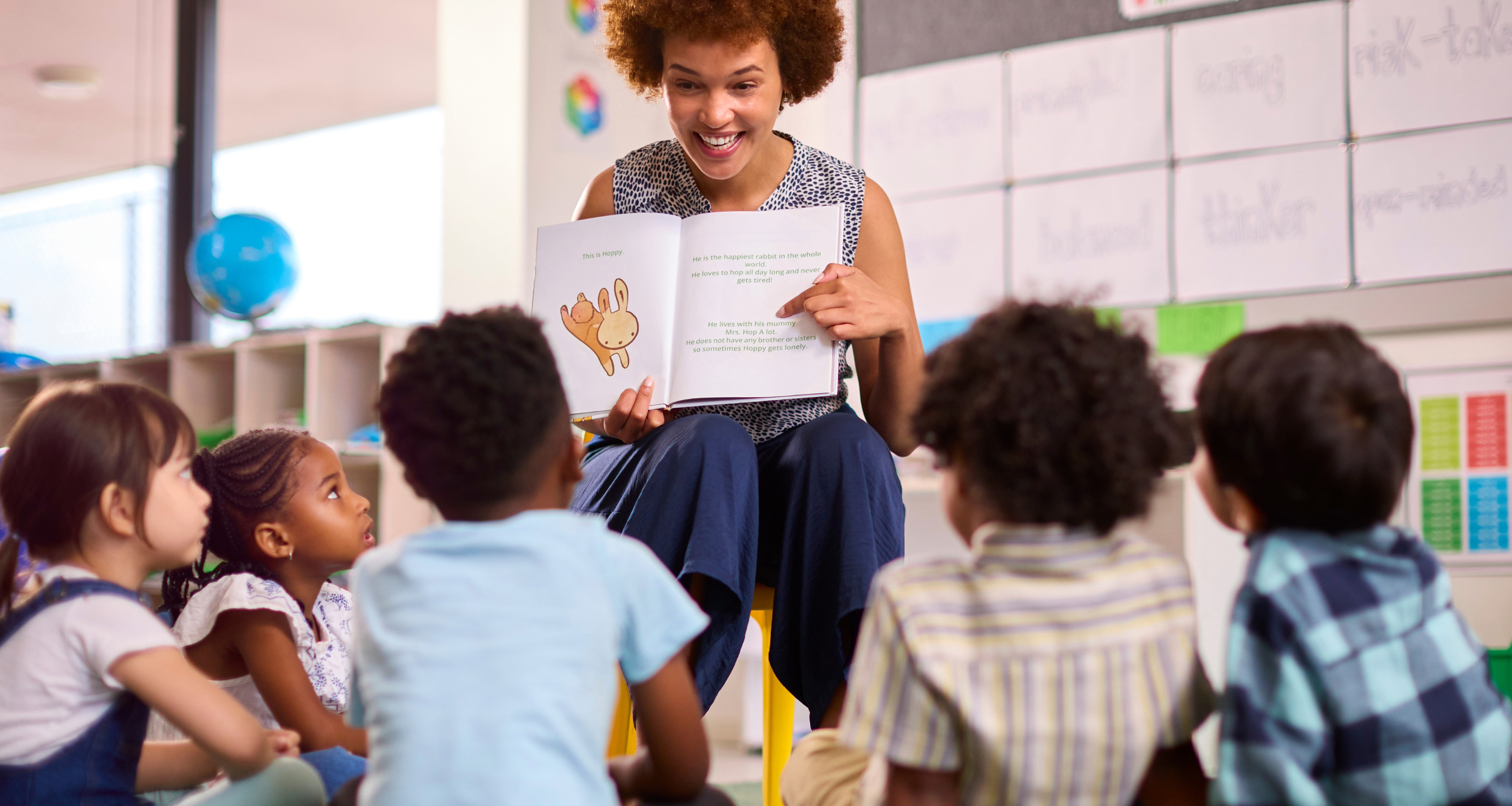 Woman reading a story to children in a circle
