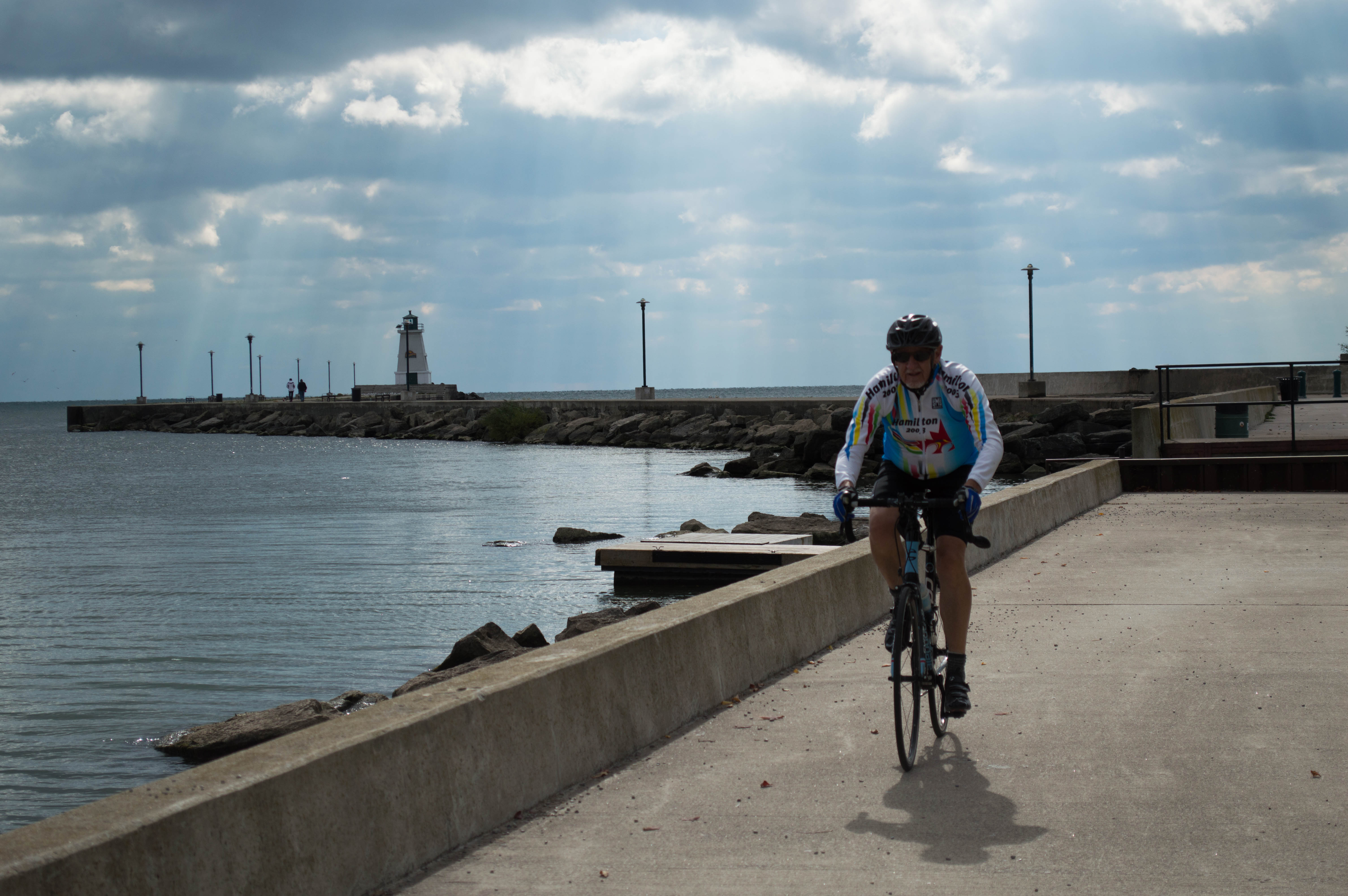 a man cycling next to a water front 