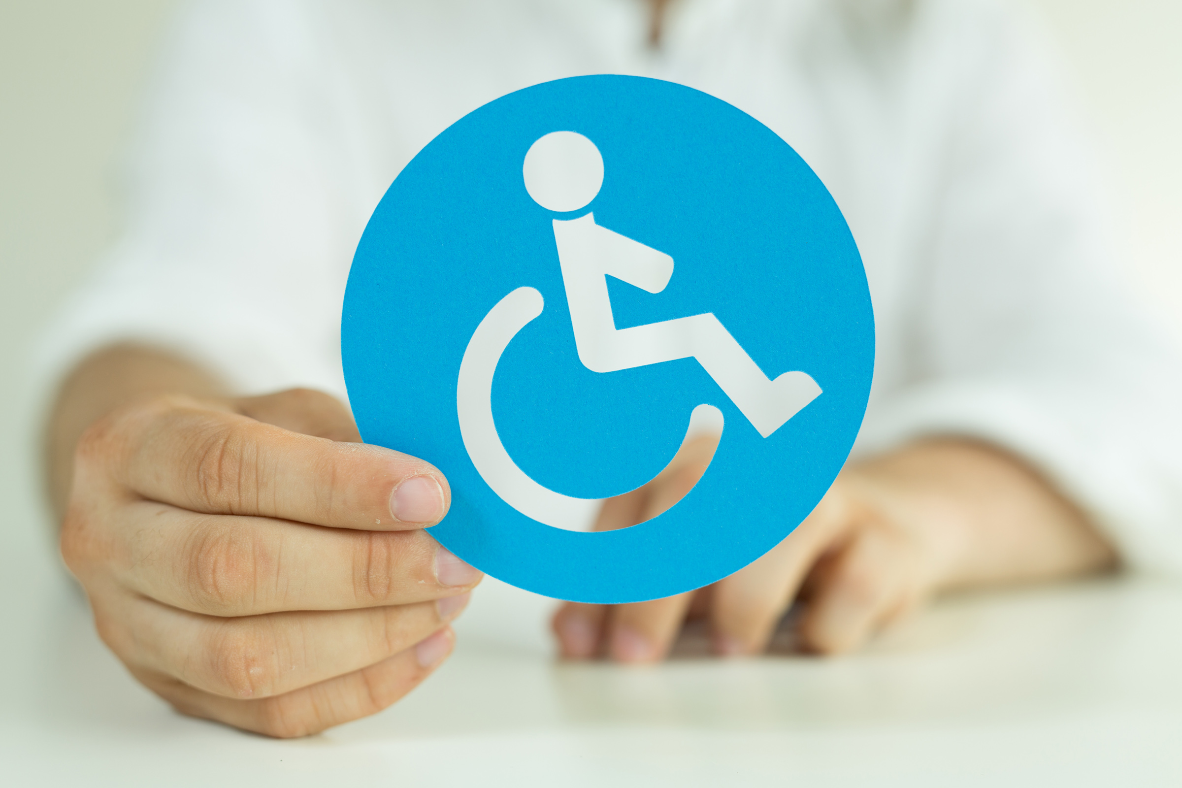 Person holding a wheelchair decal
