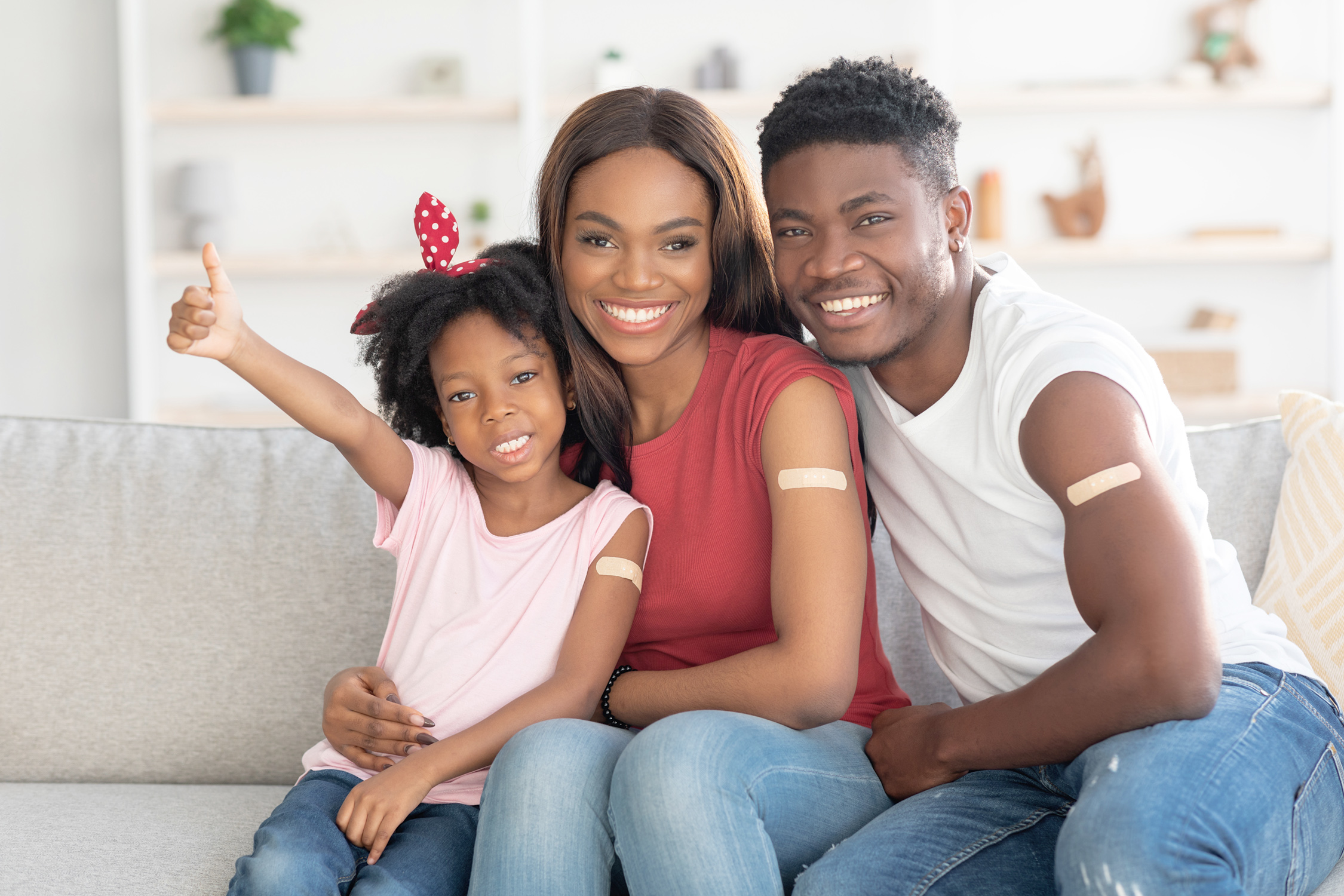 girl with woman and man showing bandages on arms