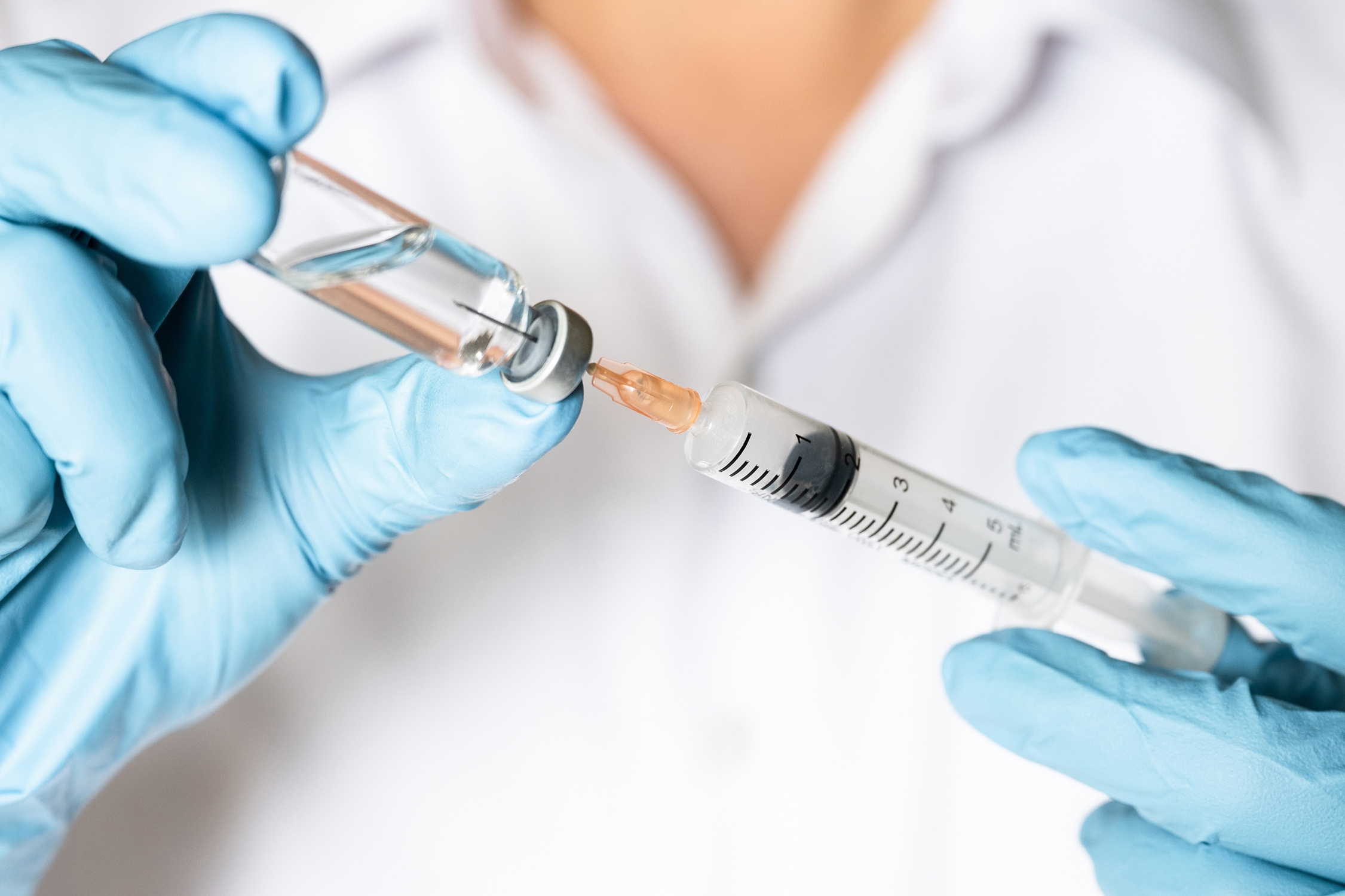 drawing up vaccine into needle