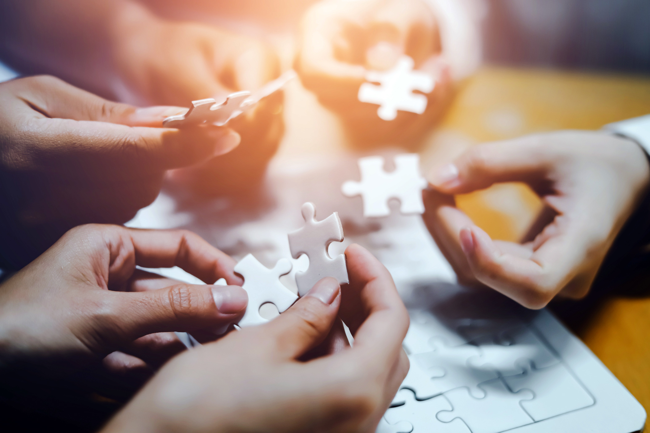 Group of people putting together a puzzle