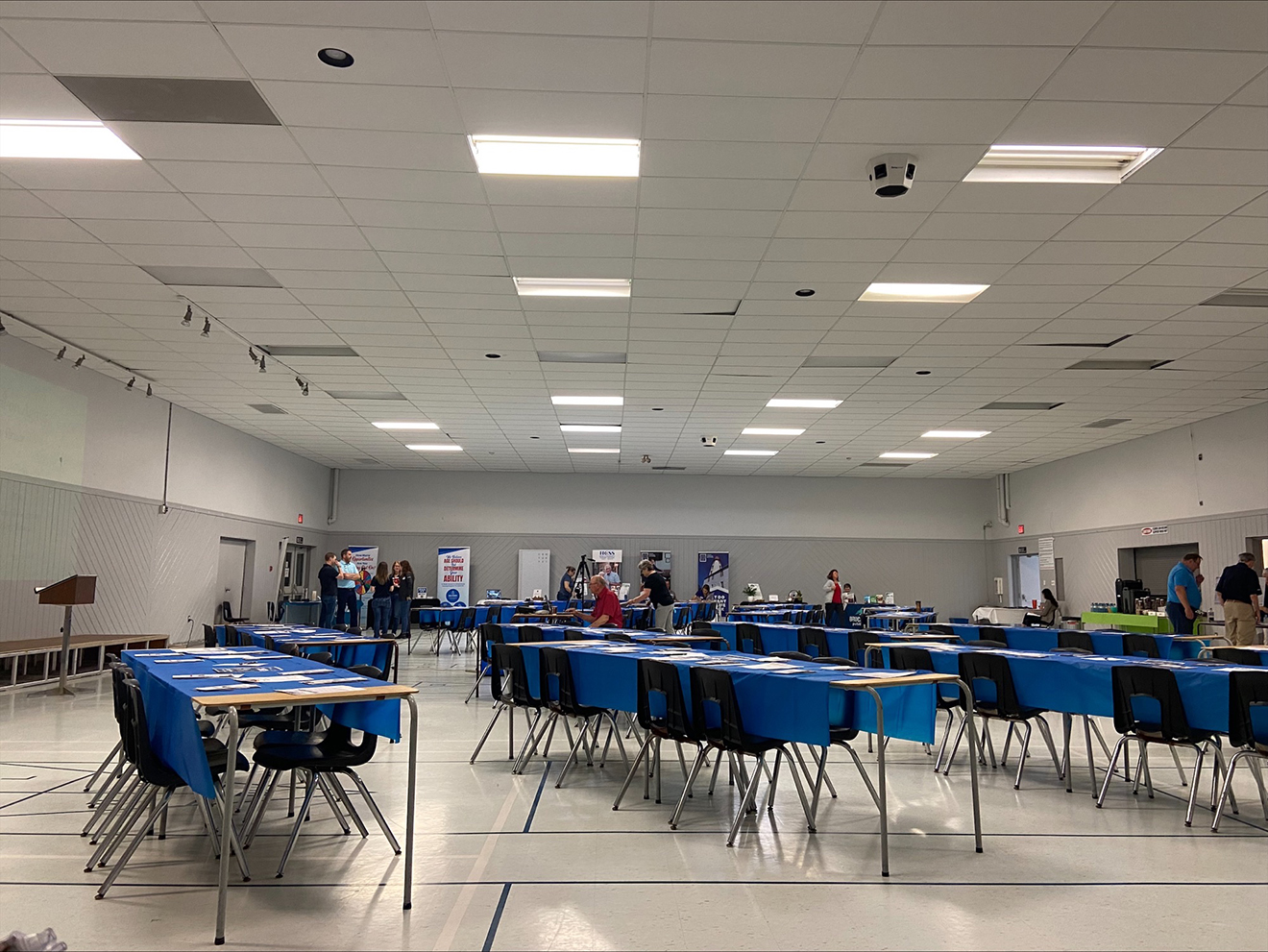 A hall with tables set for an event.