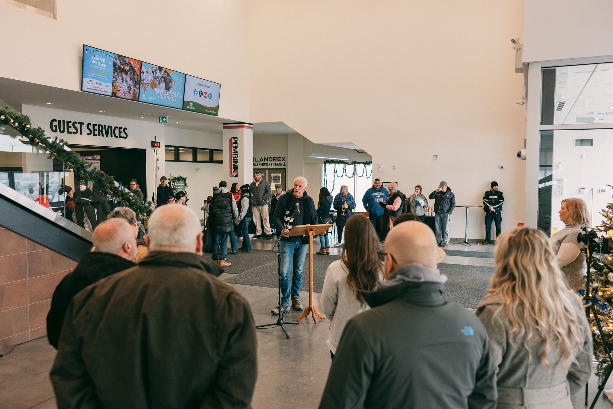 people standing in a bright foyer
