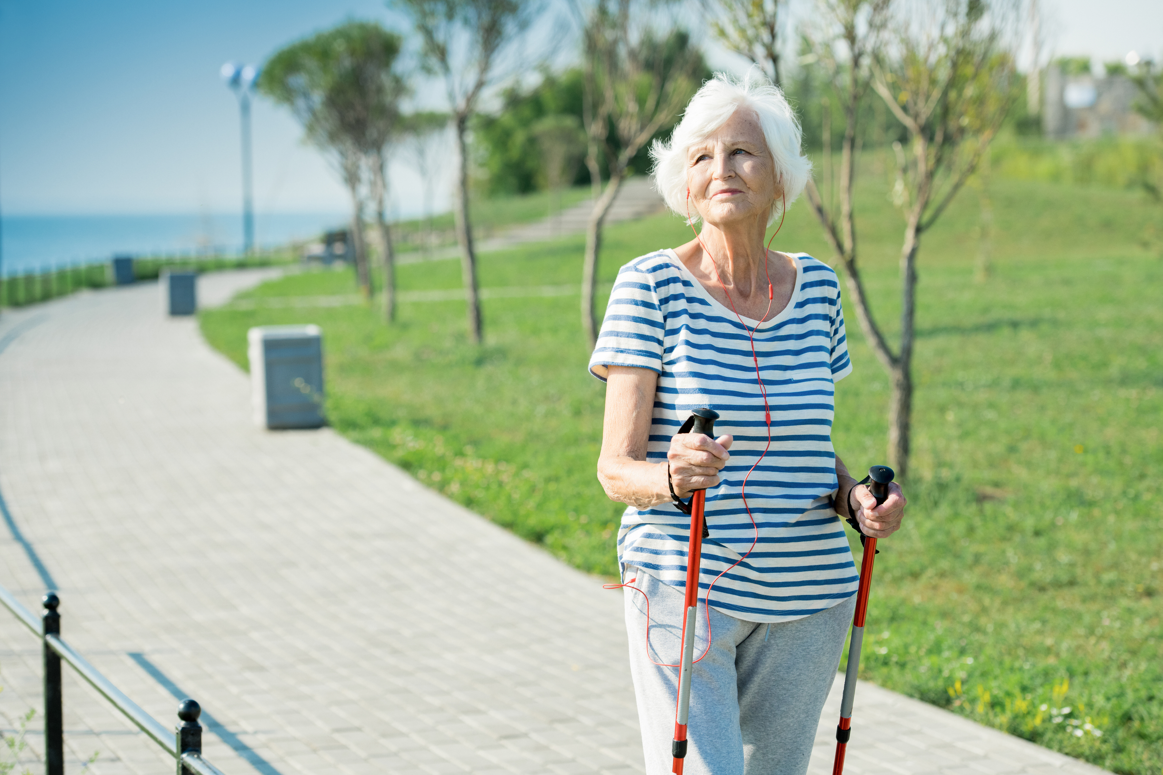 senior using Nordic poles