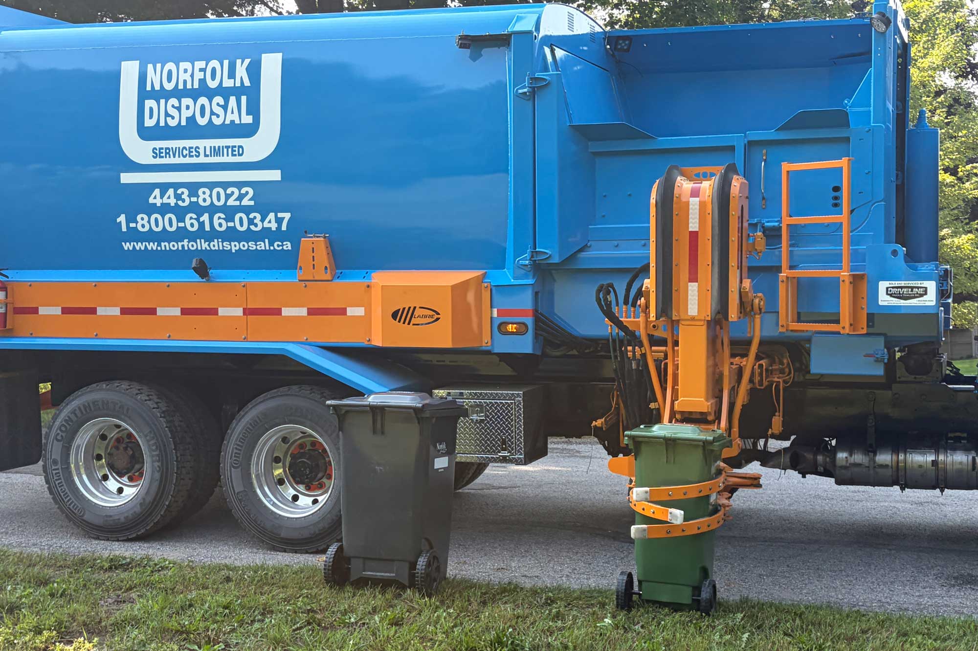 Waste truck grabbing green cart