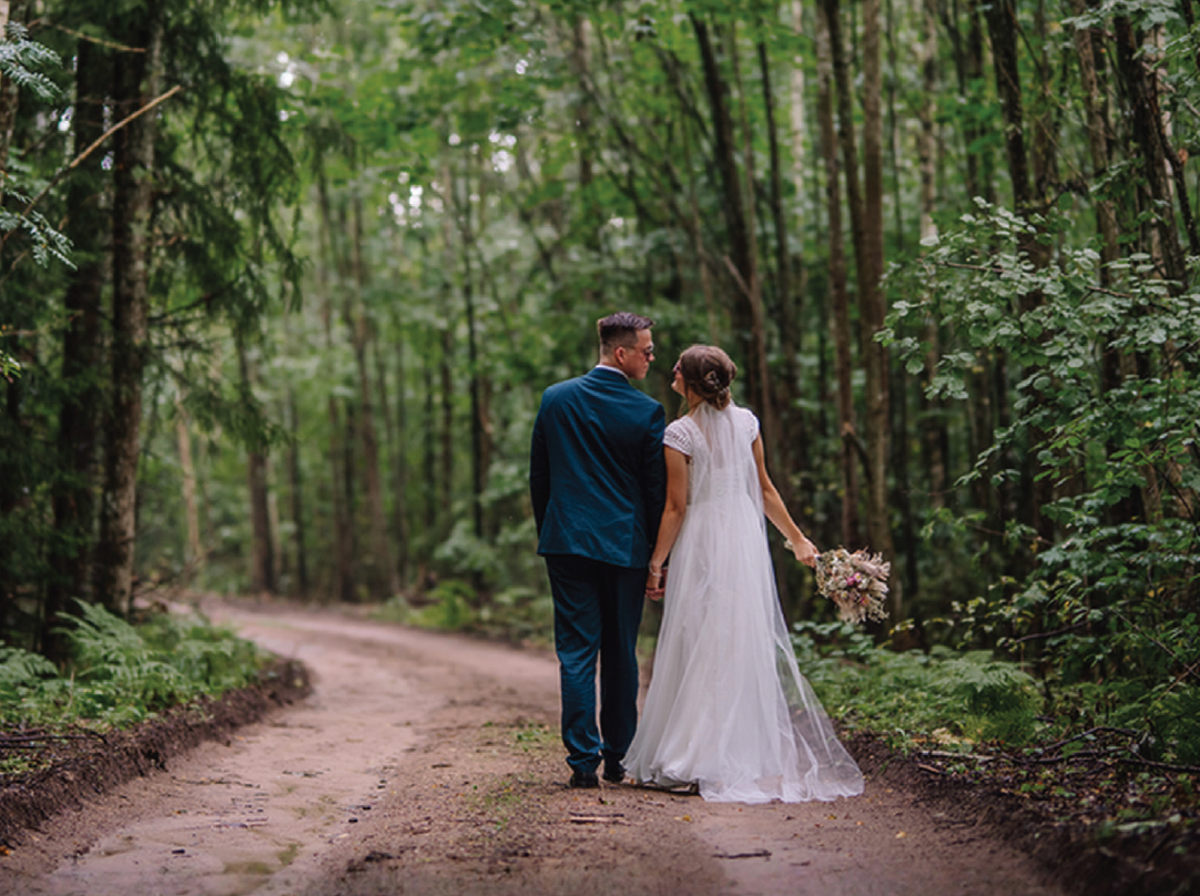 Married couple waking down a path