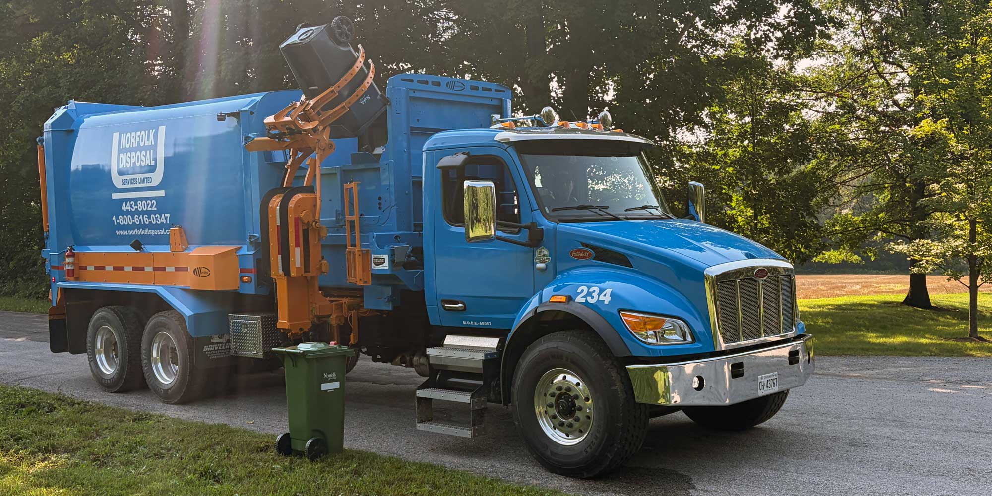 Automated waste truck lifting a cart