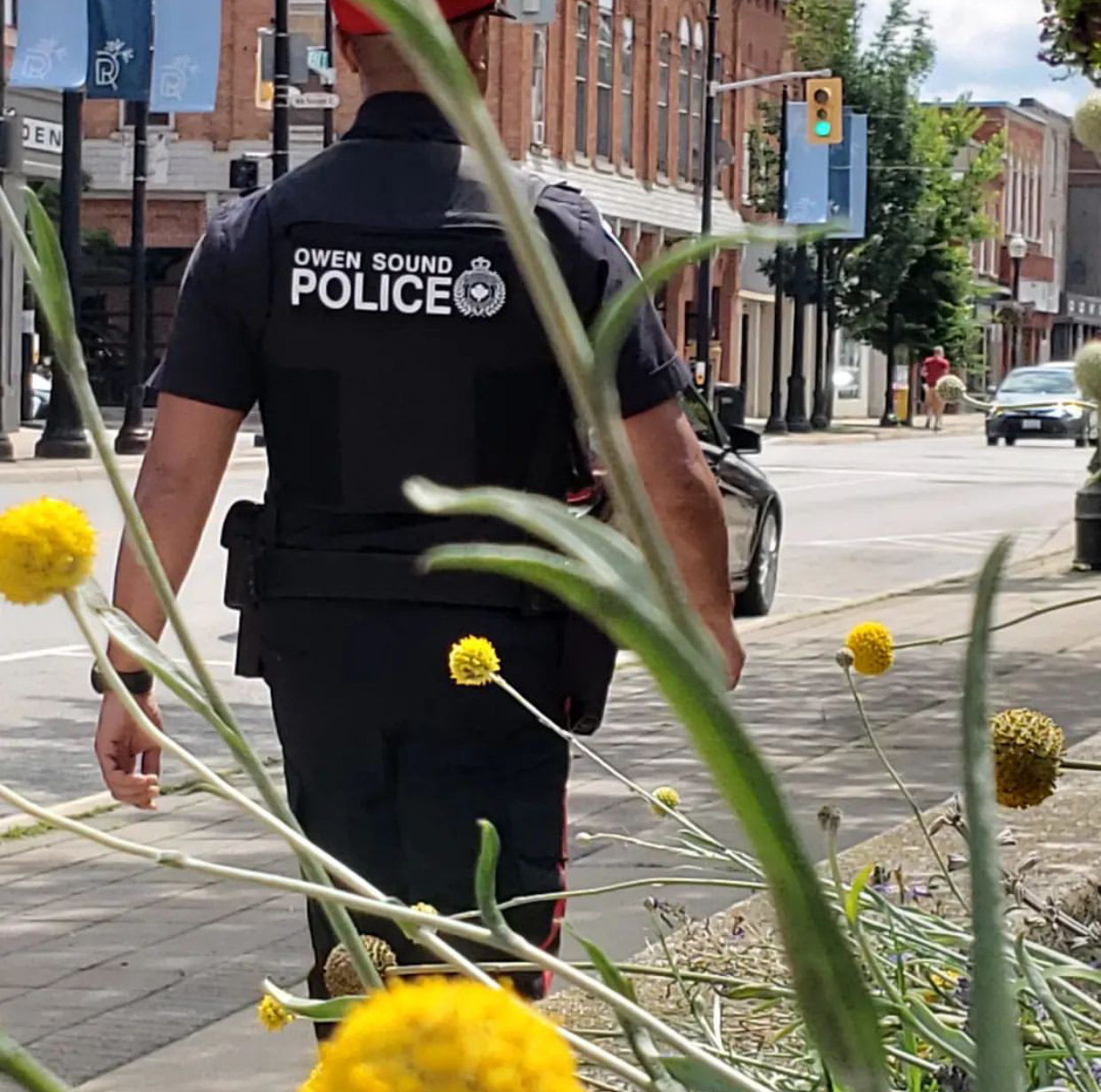 Back of an OS Police Officer walking through the River District area