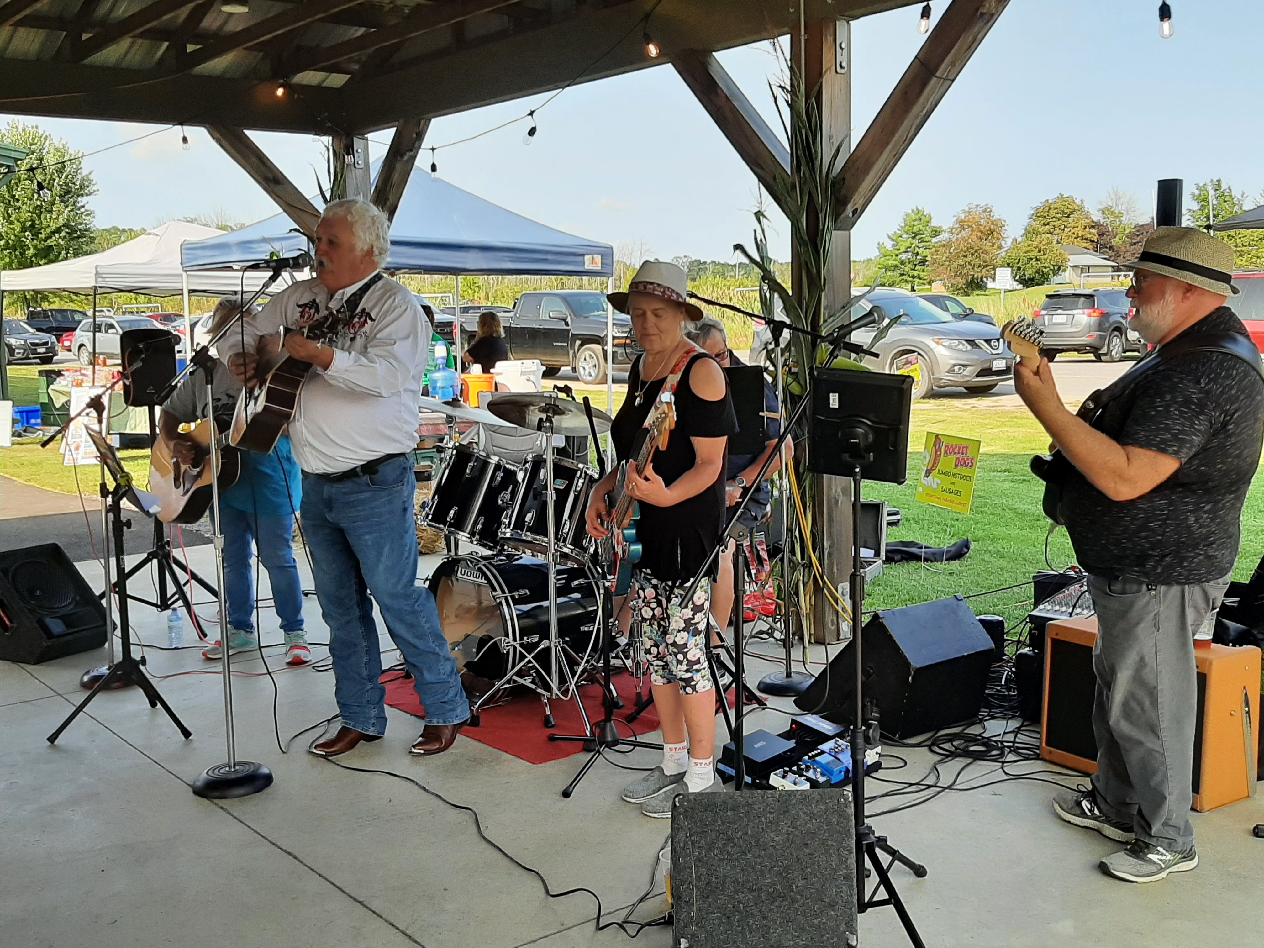 Band members playing at the farmers market