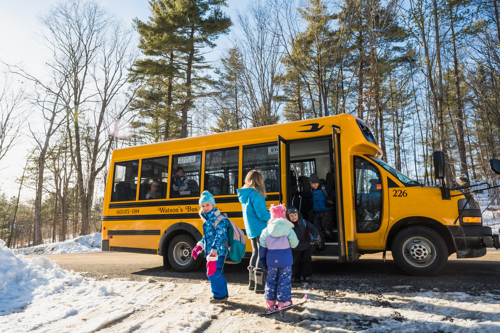 Kids getting on a school bus